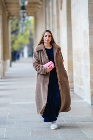 woman wearing maxi dress, teddy coat, and sneakres