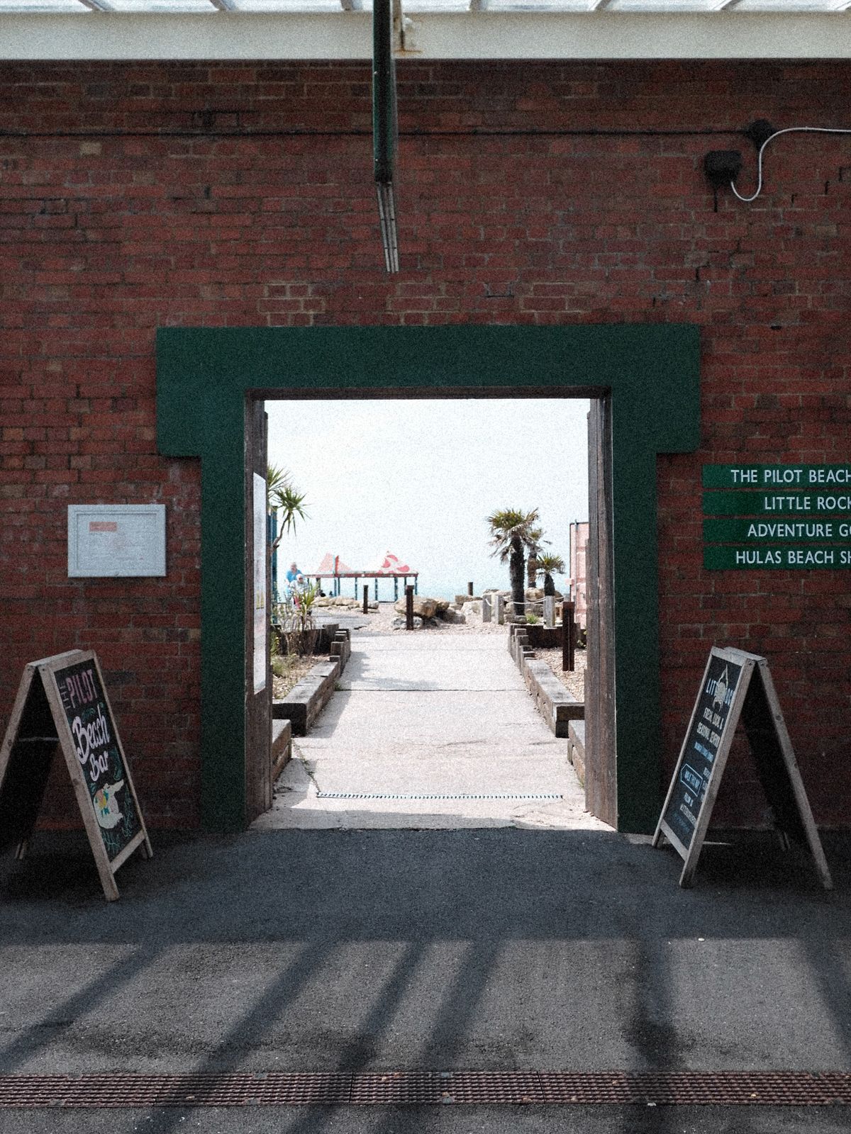 View through an arch way towards a beach