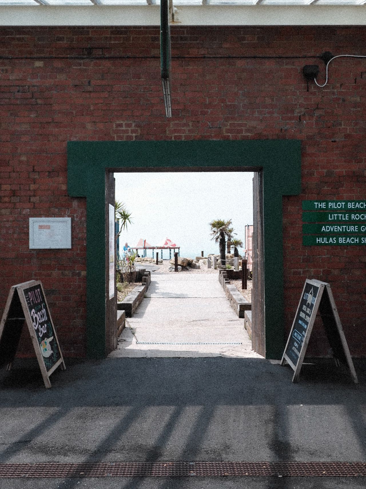 View through an arch way towards a beach