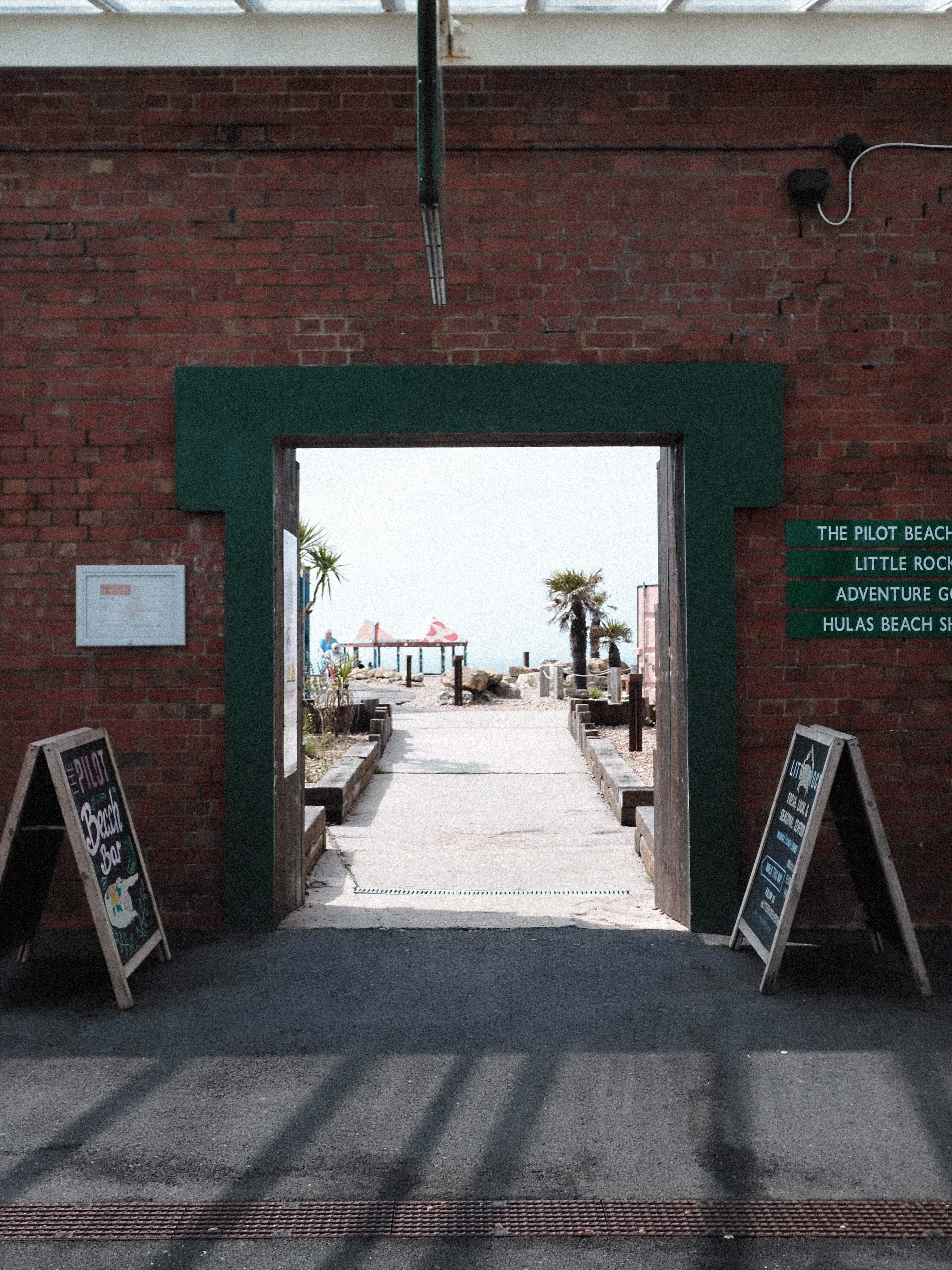 View through an arch way towards a beach