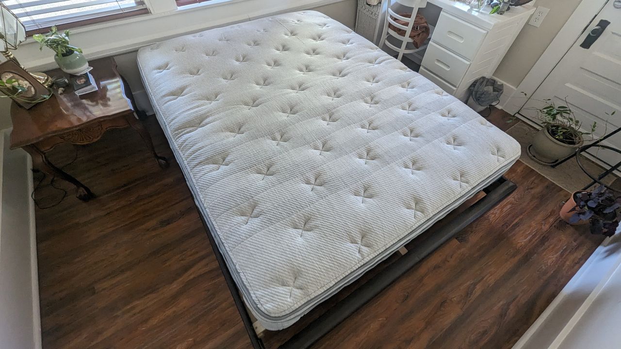 Leesa Oasis Chill Hybrid review image shows the mattress unfurled and placed on a bedframe ready for testing
