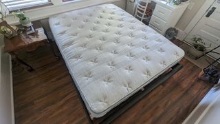 Leesa Oasis Chill Hybrid review image shows the mattress unfurled and placed on a bedframe ready for testing