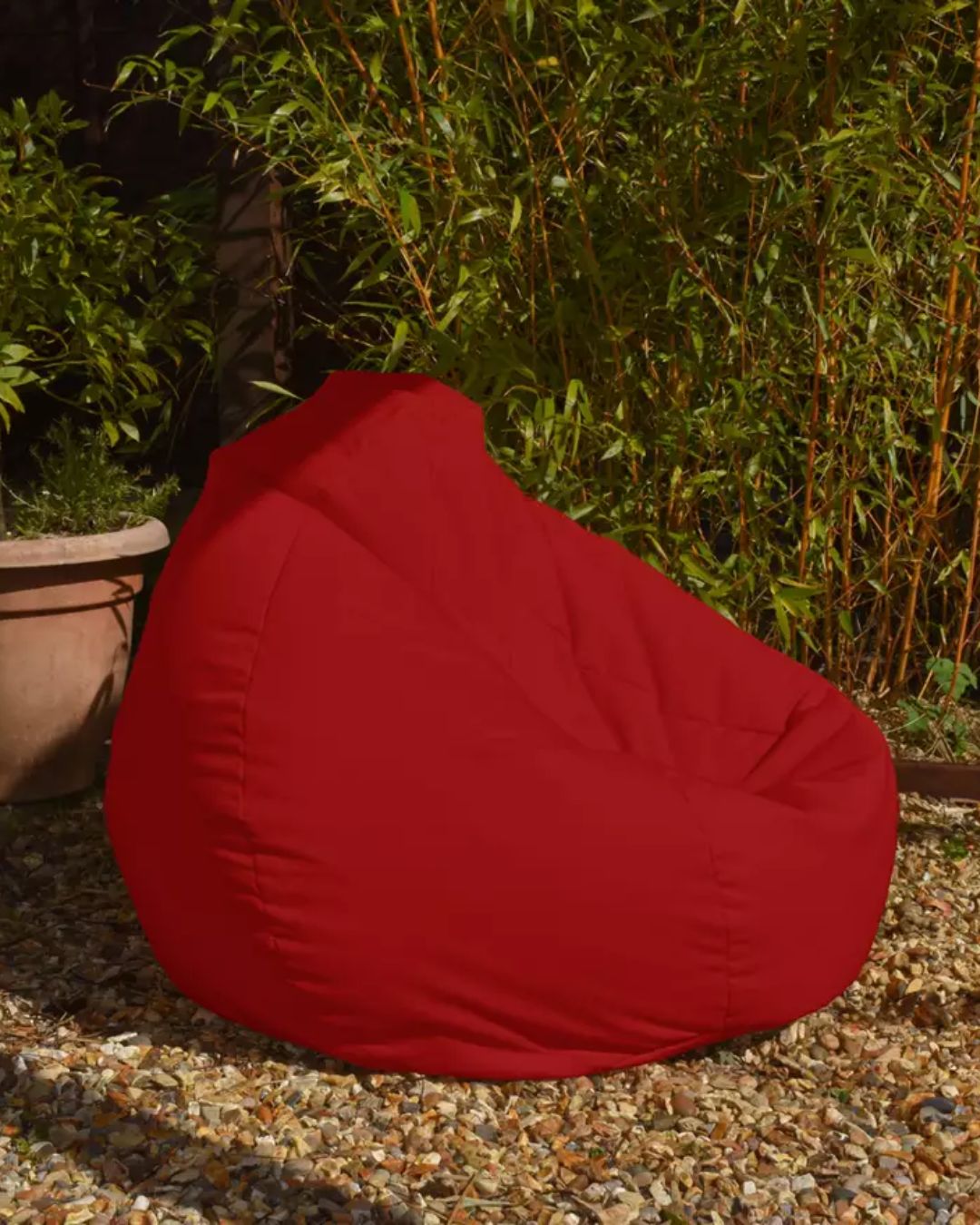 Argos Indoor Outdoor Bean Bag in Red, placed on gravel in the sun.