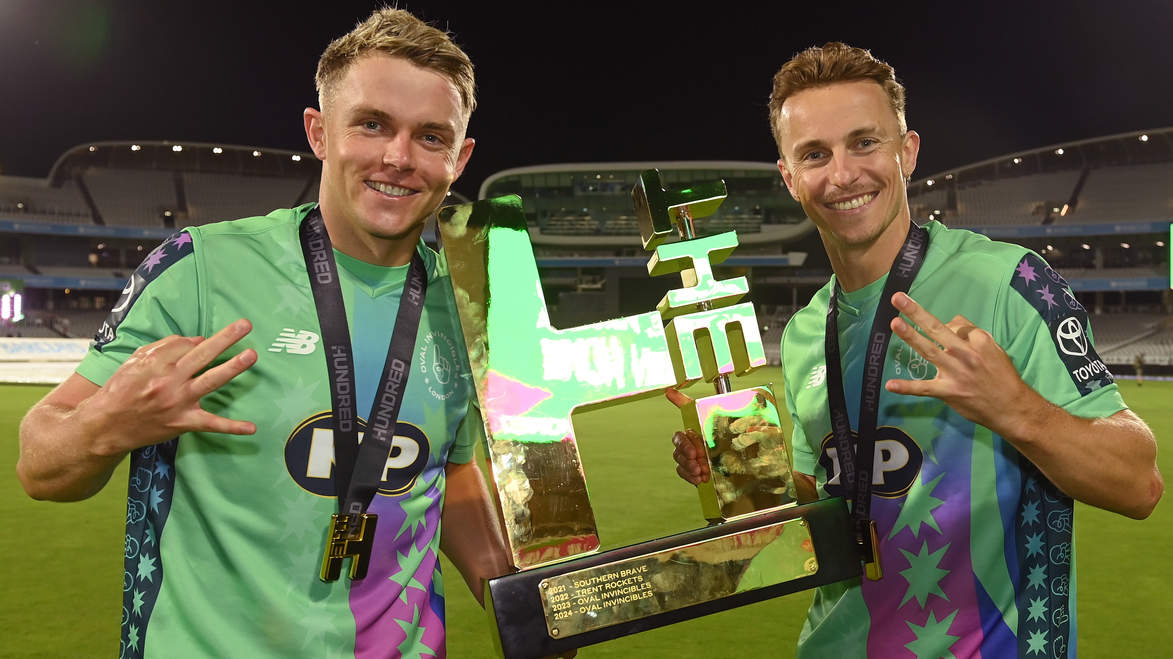 Sam Curran and Tom Curran of Oval Invincibles hold the trophy after The Hundred Final match between Oval Invincibles Men and Trent Rockets Men at Lord's Cricket Ground on August 31, 2025 in London, England. 