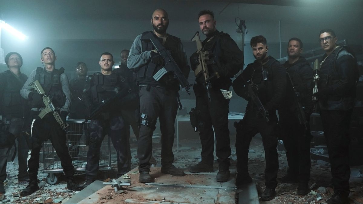 Members of the Criminal Code cast in combat gear and armed with rifles 