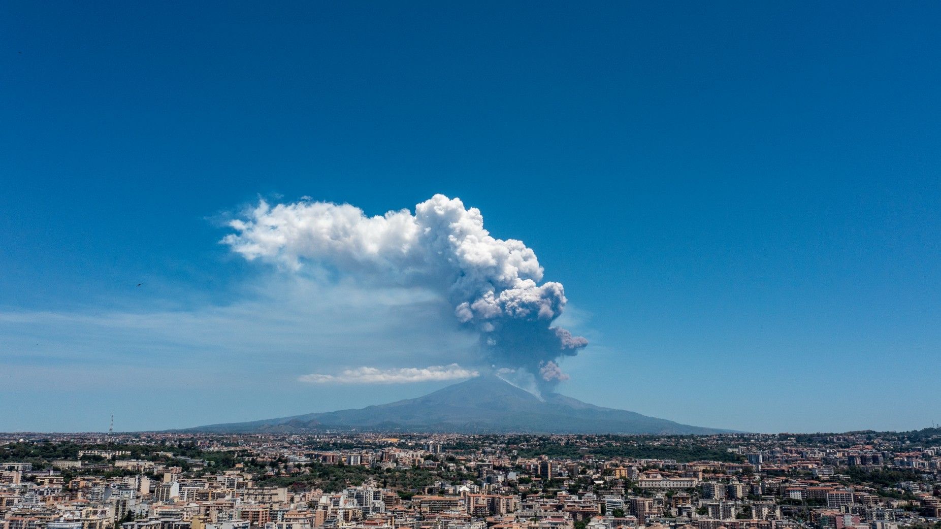 
                                Smoke and ash billow upwards after an eruption on Mount Etna in Italy
                            