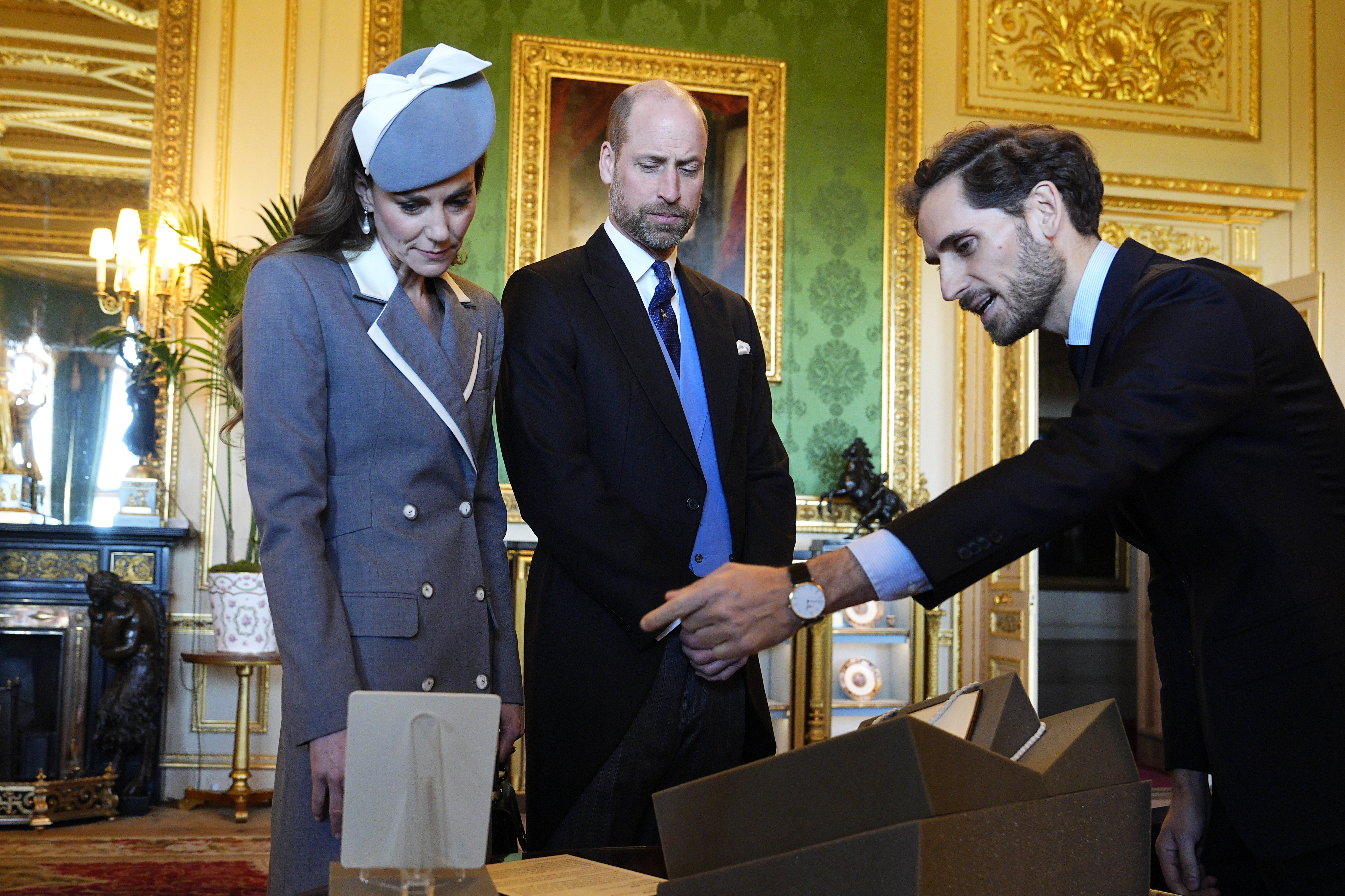 WINDSOR, ENGLAND - MARCH 18: Prince William, Prince of Wales and Catherine, Princess of Wales view items related to Nigeria from the Royal Collection exhibition, in the Green Drawing Room at Windsor Castle on the first day of State Visit by The President of the Federal Republic of Nigeria on March 18, 2026 in Windsor, England. President Bola Tinubu and First Lady Oluremi Tinubu are conducting a historic State Visit to the United Kingdom, marking the first state visit by a Nigerian leader in 37 years and the first to be hosted at Windsor Castle. (Photo by Aaron Chown - Pool/Getty Images)
