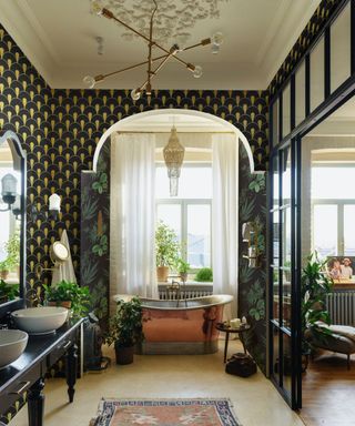 An art deco entryway with an arched doorway and dark green and gold wallpaper