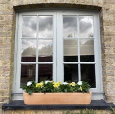 brick house with planted windowsills and brick house