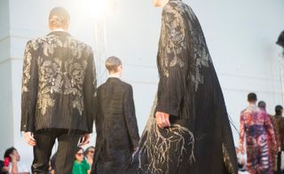 Male models wearing black clothes from the Alexander McQueen S/S 2018 collection
