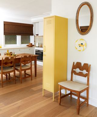 yellow tall storage locker next to wooden chair in kitchen