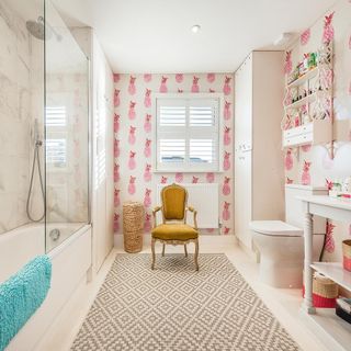 bathroom with pineapple wallpaper wall and bathtub and toilet