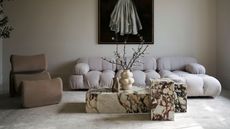 minimalist living room with calacatta viola marble coffee table, designer sofas and a neutral color palette