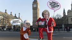 rotesters dressed as Rupert Murdoch oppose the Sky takeover outside Parliament