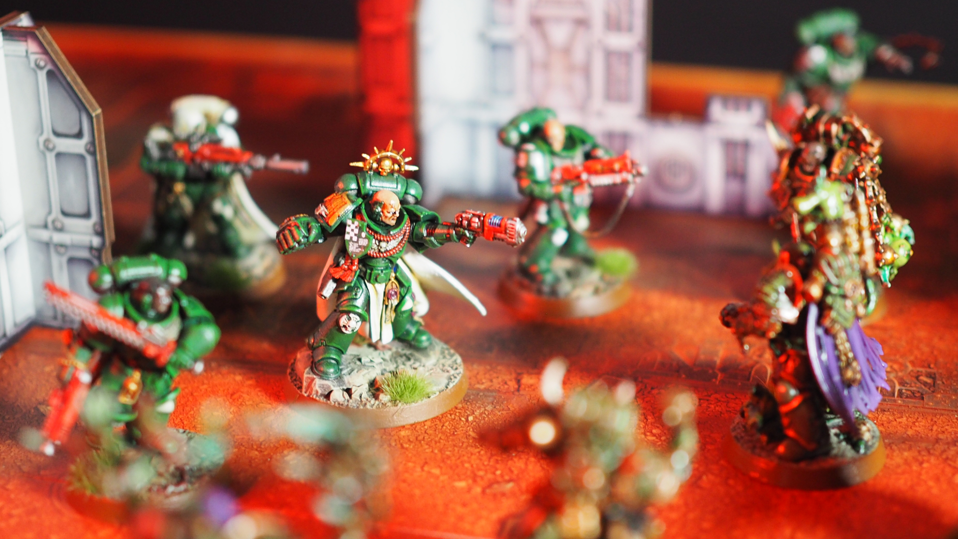 Space Marines and Plague Marines face off on a red battlefield littered with rubble