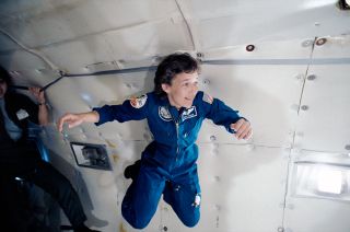 Mary Cleave floating in midair during her STS-61B mission training on board the KC-135 reduced gravity aircraft in 1985.