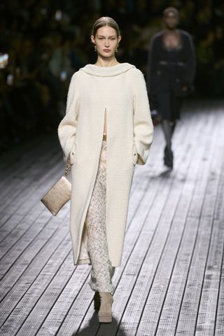 woman on the runway in an elegant Chanel coat