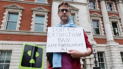 A man in London holds a protest sign against superintelligent AI