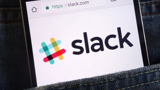 Slack logo on a smartphone display in a denim pocket