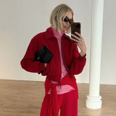 Elsa Hosk takes a mirror selfie wearing the pink and red colour trend.