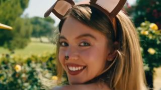 A close up of Sydney Sweeney wearing dog ears and smiling in Euphoria