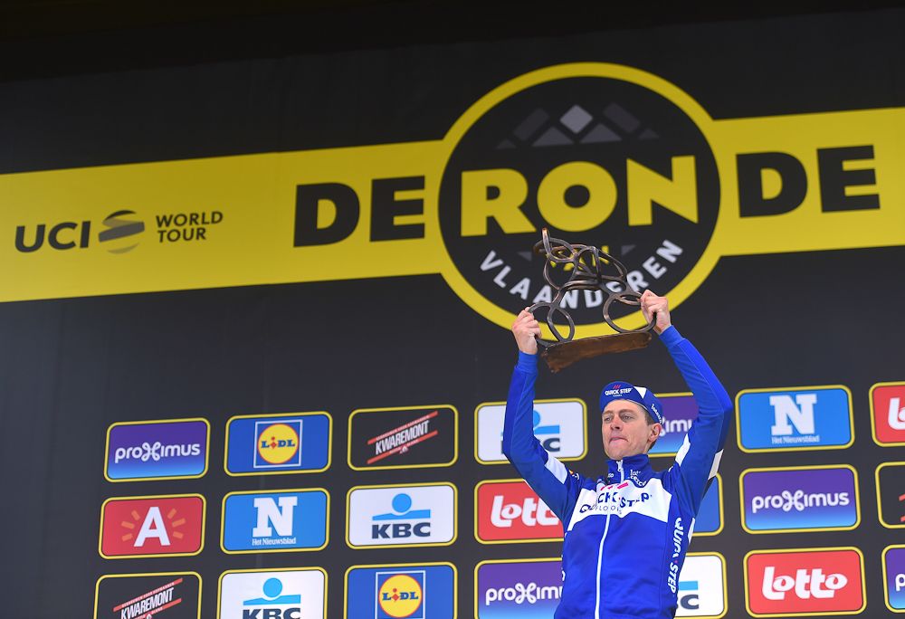 Niki Terpstra celebrates on the podium after winning Tour of Flanders