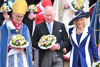 Camilla, Duchess of Cornwall and Prince Charles, Prince of Wales hold nosegays as they attend the Royal Maundy Service