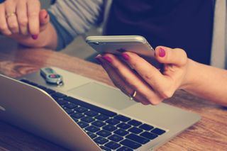 Logo design inspiration: woman with laptop on desk and phone in hand