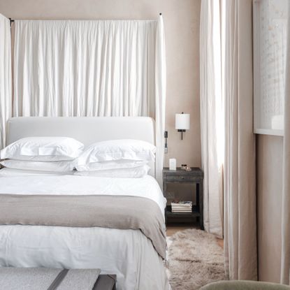 bed with white duvet set in beige coloured bedroom