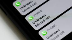 A photo of missed calls displaying an "unknown" caller on an iPhone.
