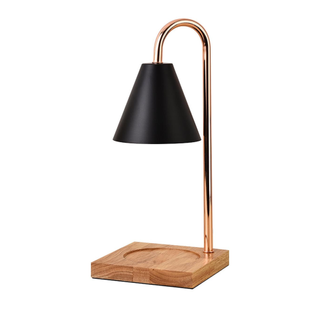 A black and copper candle warmer lamp with wooden base