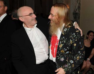 Phil Collins and John Kalodner at a party