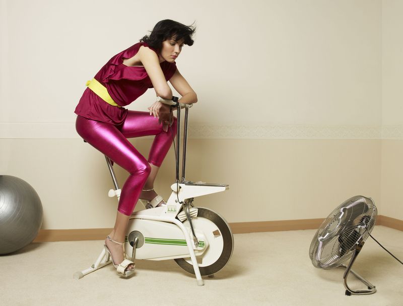 A woman on an old-fashioned exercise bike