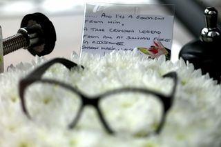 A pair of glasses rests on flowers at Ronnie Corbett's funeral