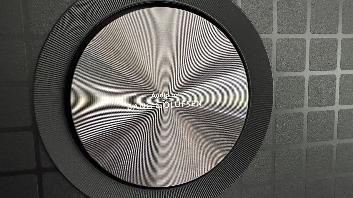 A close-up of one of the circular Bang &amp; Olufsen speakers on the 65-inch TCL C7K Mini LED TV.
