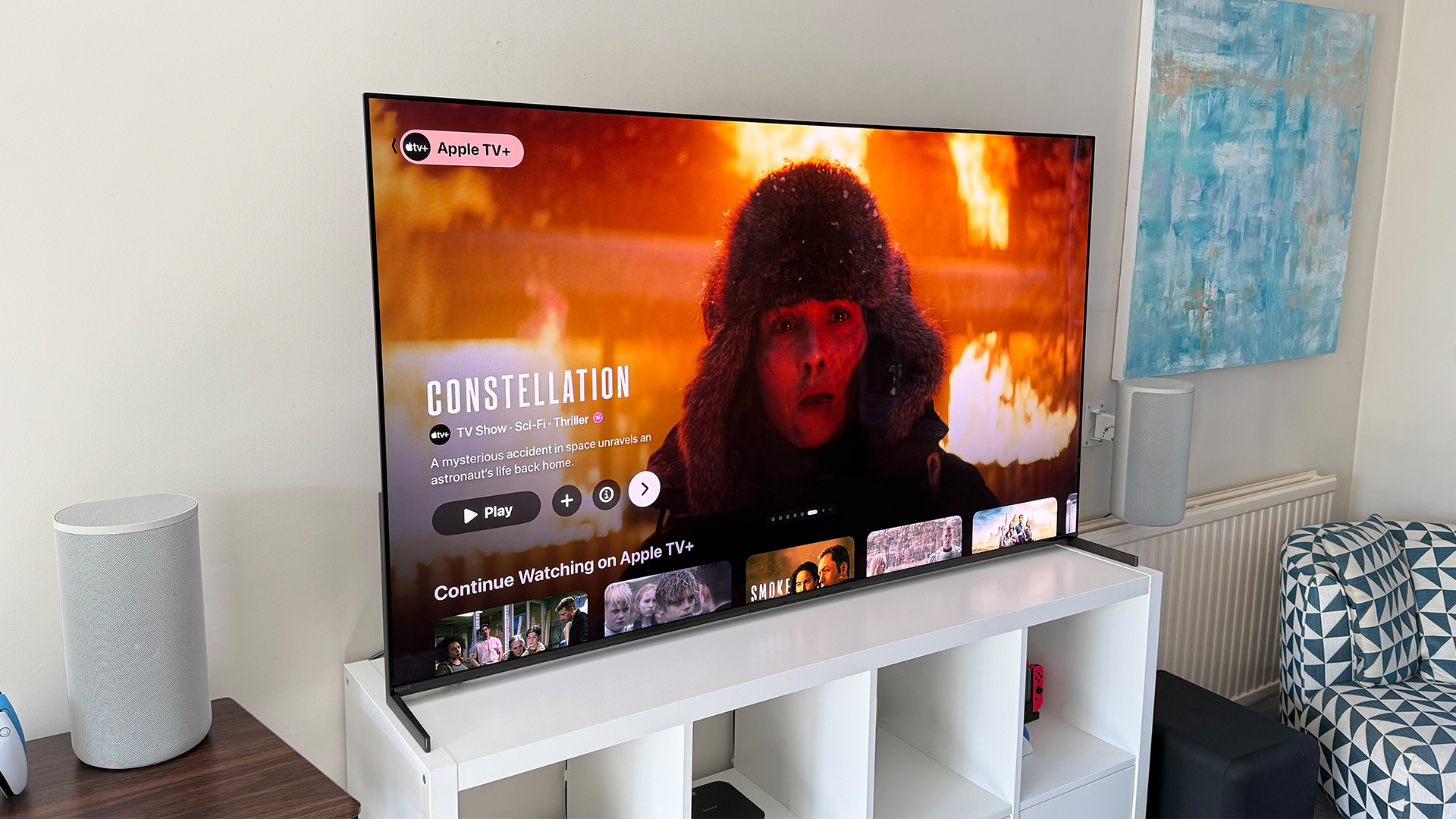 Apple TV+ TV streaming service on TV in living room, on screen is Constellation