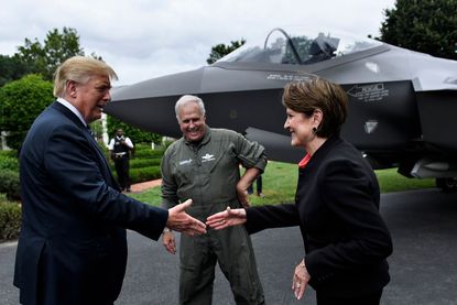 Lockheed Martin CEO Marillyn Hewson shakes hands with President Trump.