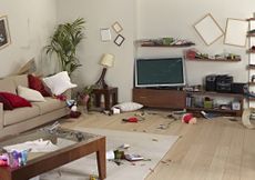 Furniture and belongings in a living room damaged by an earthquake.