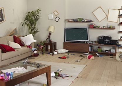 Furniture and belongings in a living room damaged by an earthquake.
