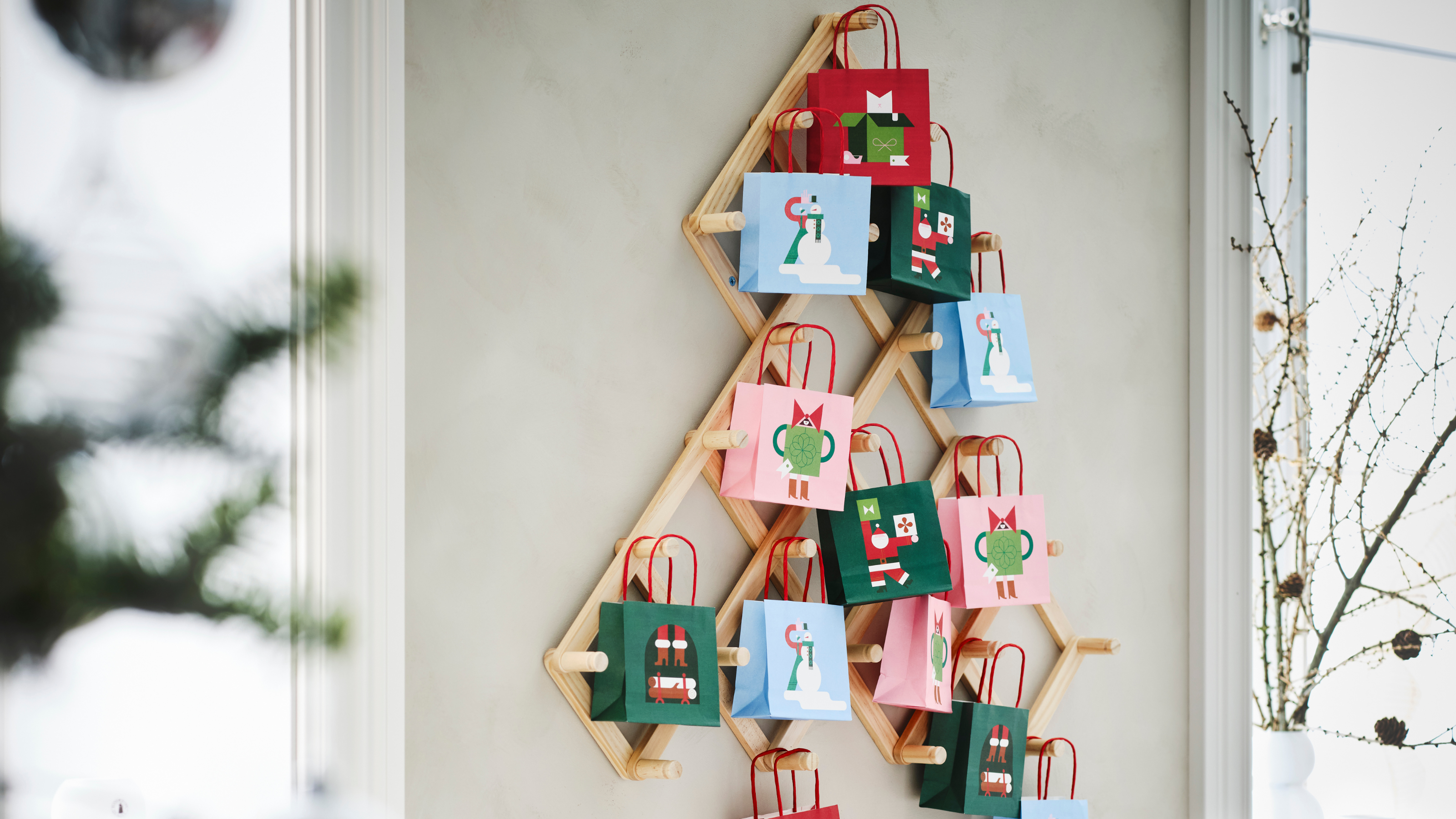 IKEA VINTERFINT peg tree holding festive party bags.