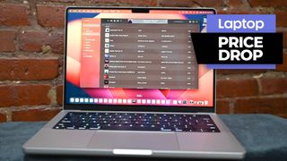 2023 MacBook Pro M2 Pro with price drop badge against a brick wall