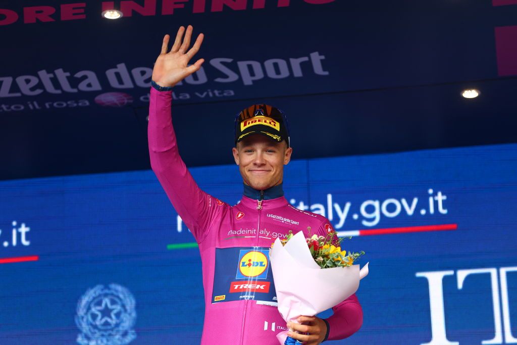 Team Lidl-Trek's Italian rider Jonathan Milan celebrates his best sprinter's cyclamen jersey during the podium ceremony of the 8th stage of the 107th Giro d'Italia cycling race, 152km between Spoleto and Prati di Tivo, on May 11, 2024. (Photo by Luca Bettini / AFP)