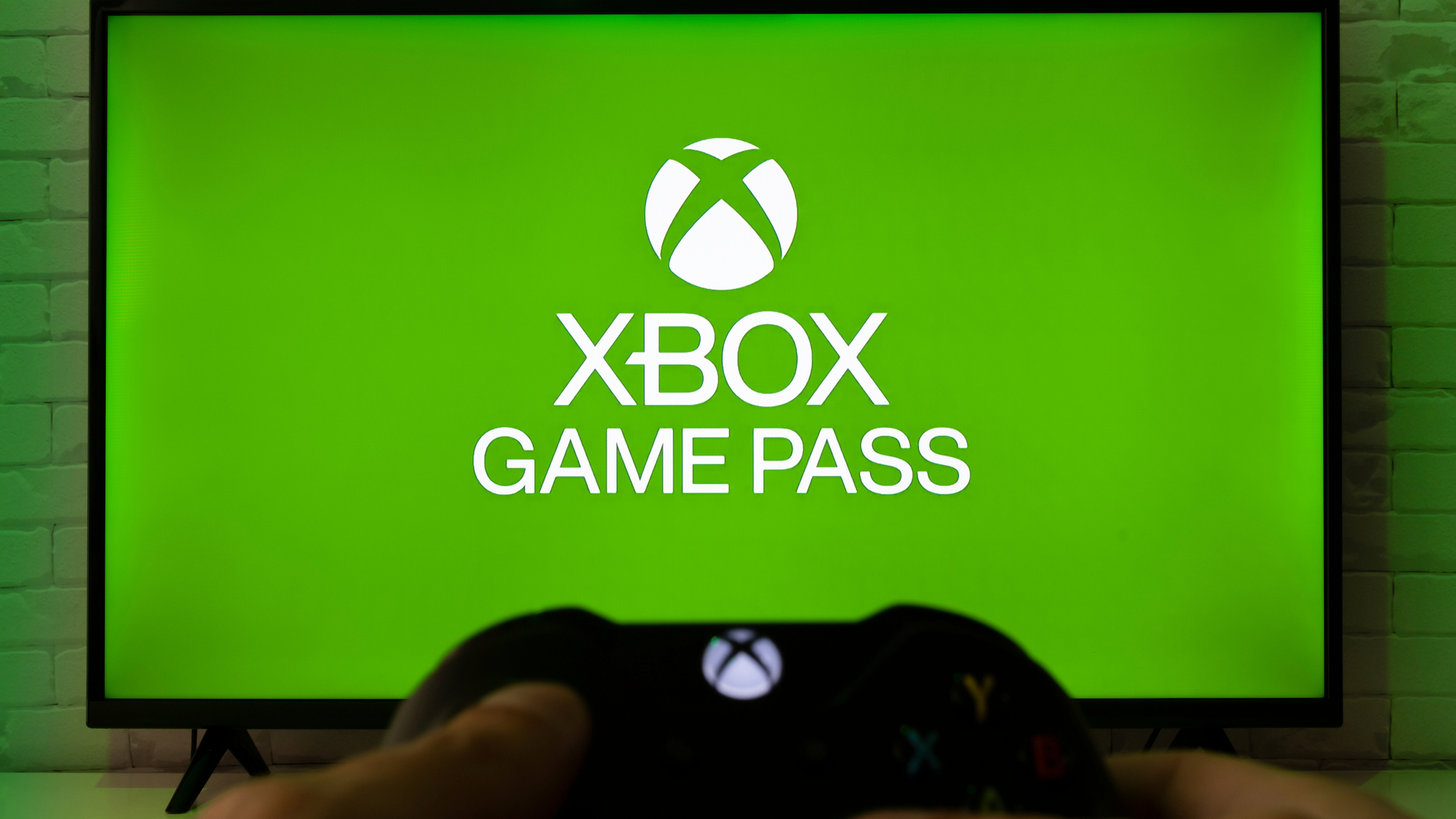Xbox Game Pass splash screen with someone holding a controller