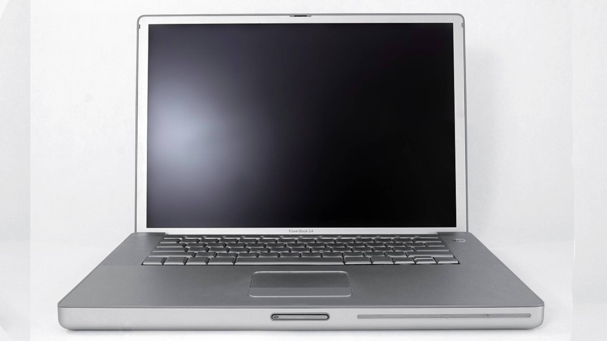 An open Apple PowerBook G4 on gray background