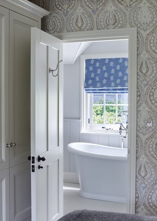 Small bathroom with a bright Roman blind
