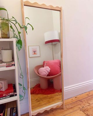 @kmartaus mirror leaning on white wall with crisp trim, brighter accessories in the distance
