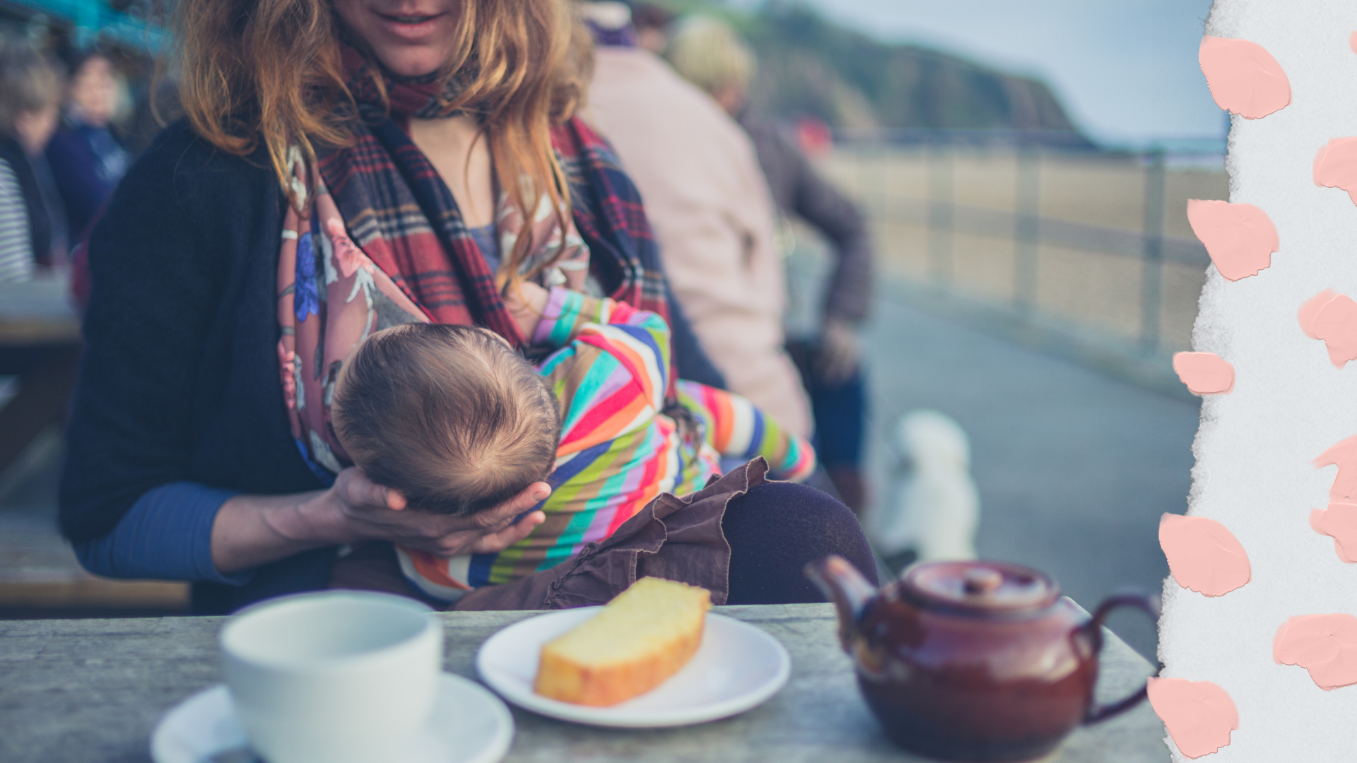 Woman breast feeding a baby outside with tea and cake