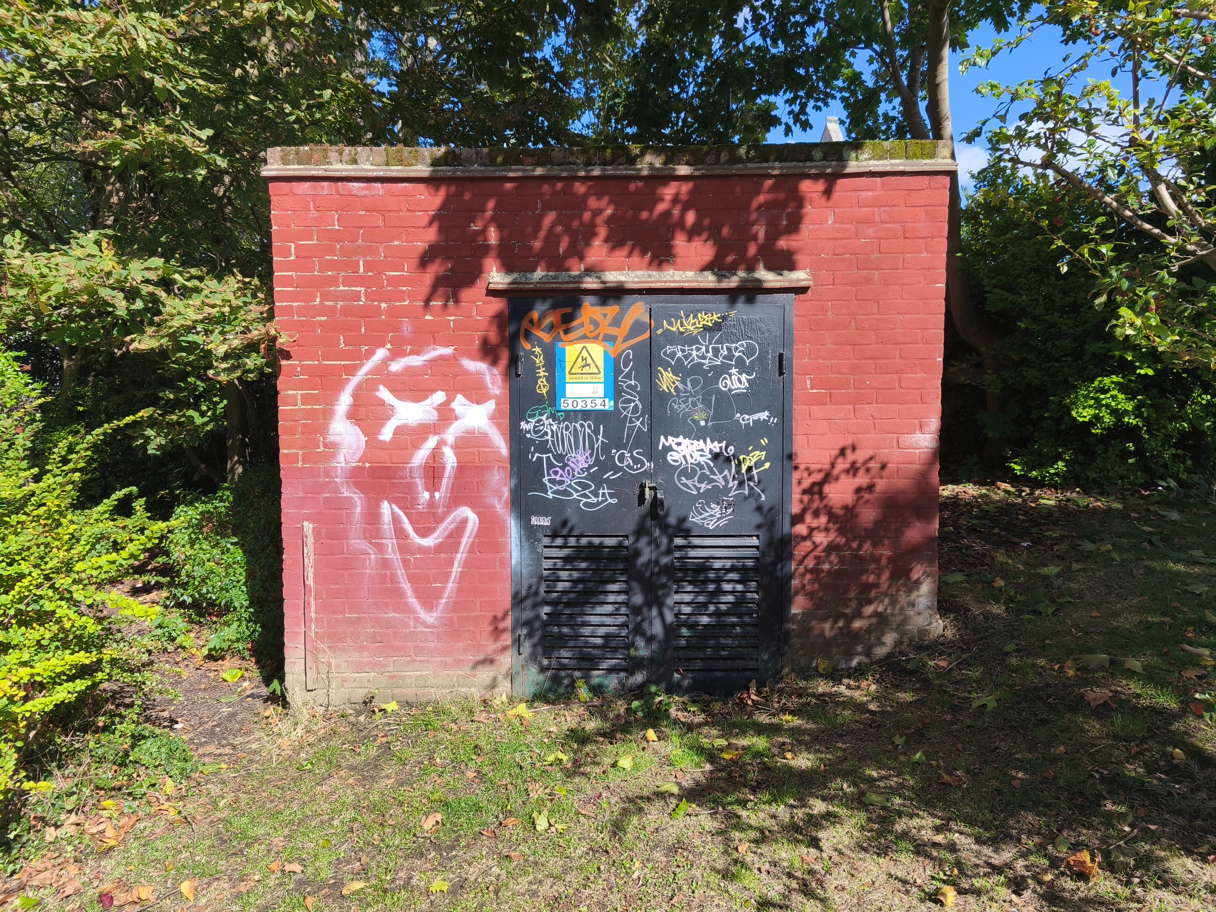 A utility shed with graffiti on it