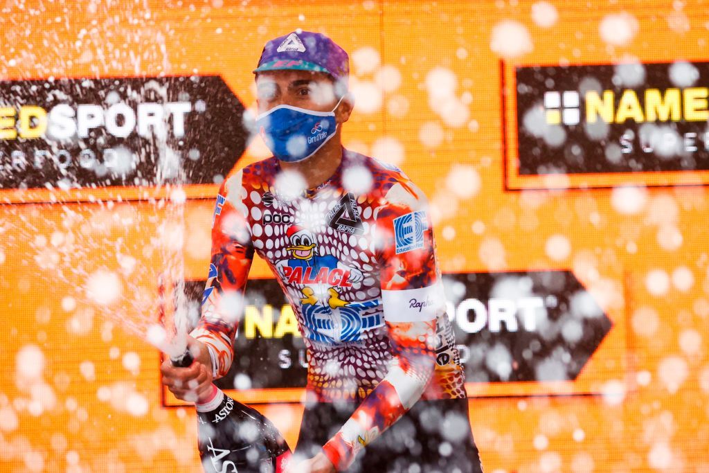 Team Education First rider Portugals Ruben Guerreiro celebrates on the podium with a bottle of champagne after winning the 9th stage of the Giro dItalia 2020 cycling race a 208kilometer route between San Salvo and Roccaraso on October 11 2020 Photo by Luca Bettini AFP Photo by LUCA BETTINIAFP via Getty Images