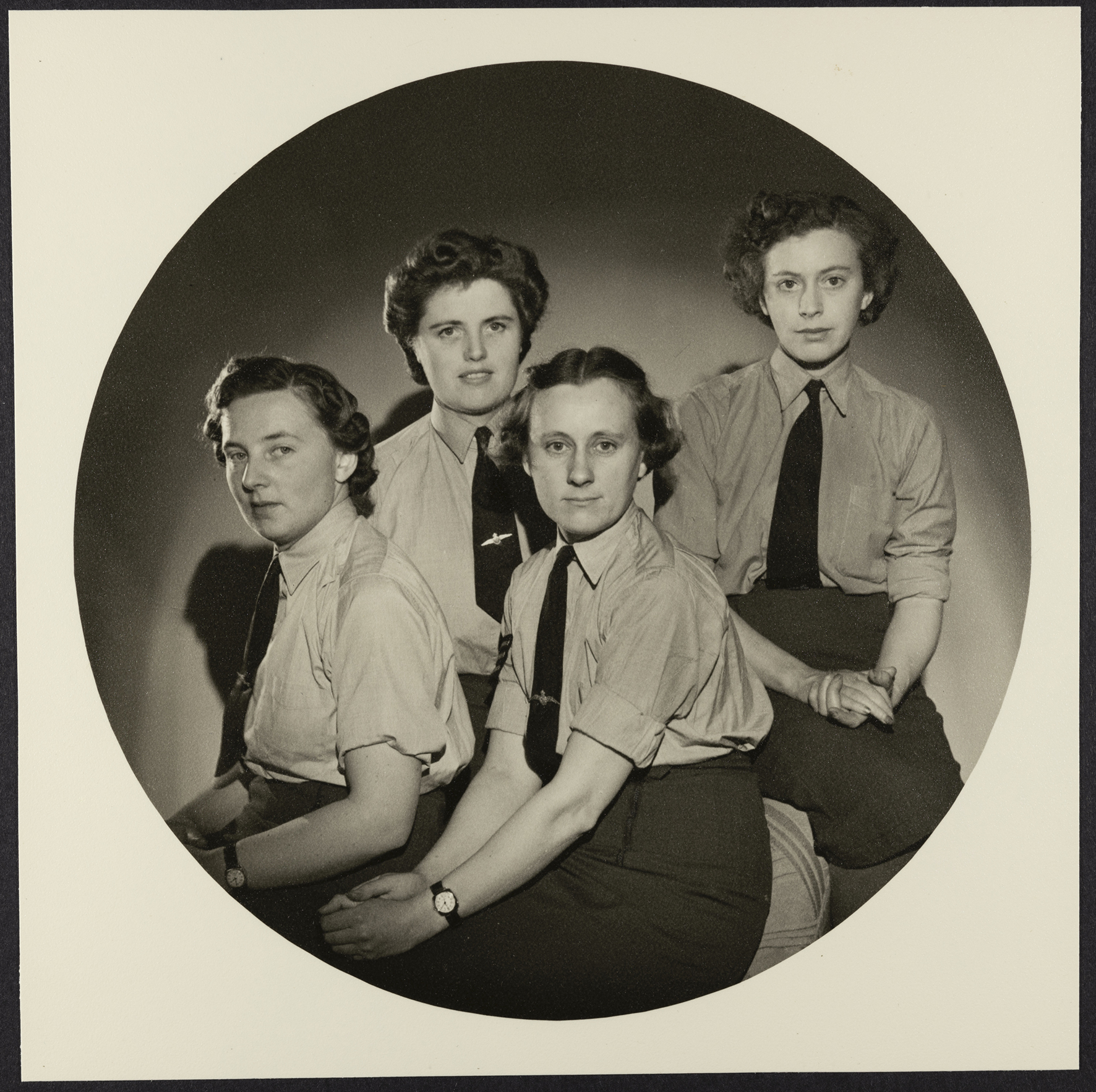 Portrait of WAAF personnel from the Stills department of the RAF's Film Production Unit, at RAF Iver Heath (Pinewood Studios), the photograph shows: (left to right) Leading Aircraftwoman Molly Plowman, Captain Lillian Lewis, Sergeant Knicky Chapman and Leading Aircraftwoman Freda Pocock